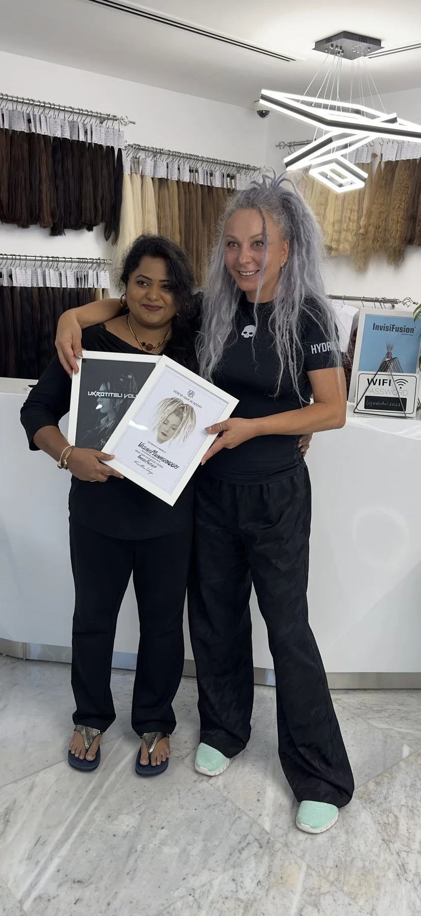 Stylette stylist celebrating hair extension training with an educator